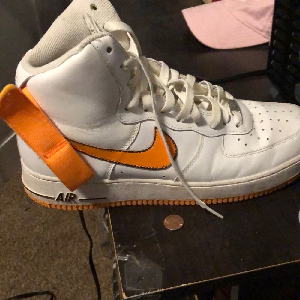 orange and white nike adorns.